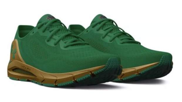 View of green, navy, and gold Under Armour shoes.